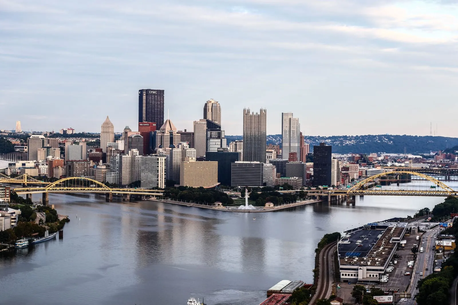 A downtown on a point where rivers meet, yellow bridges crossing to either side